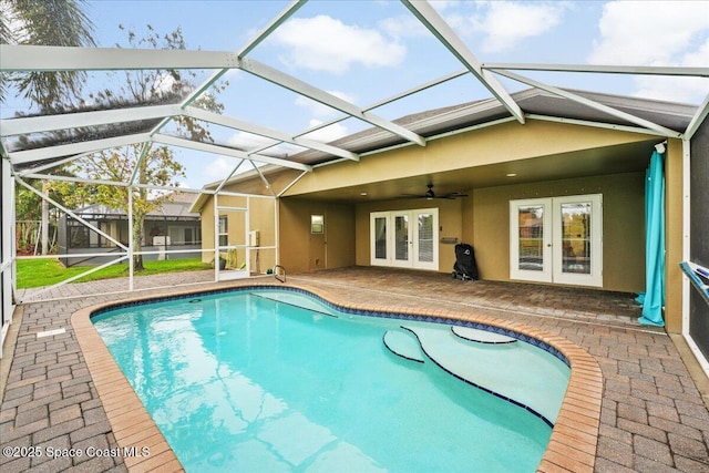 outdoor pool featuring a ceiling fan, french doors, a patio area, and a lanai