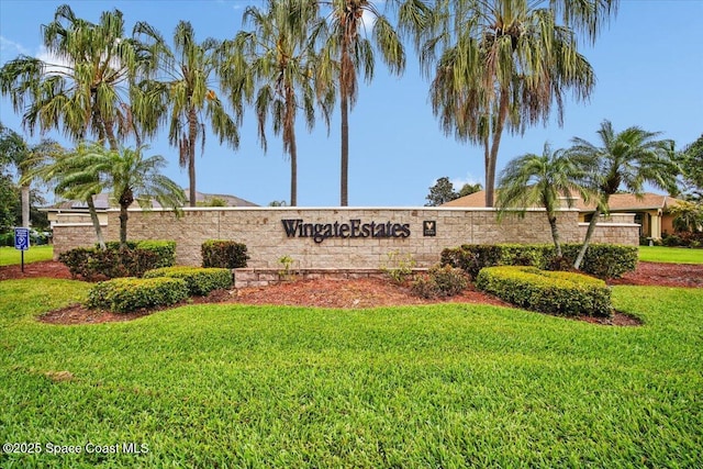 community sign featuring a lawn