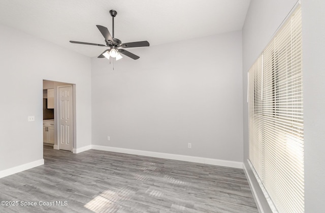 unfurnished bedroom featuring ceiling fan, baseboards, and wood finished floors