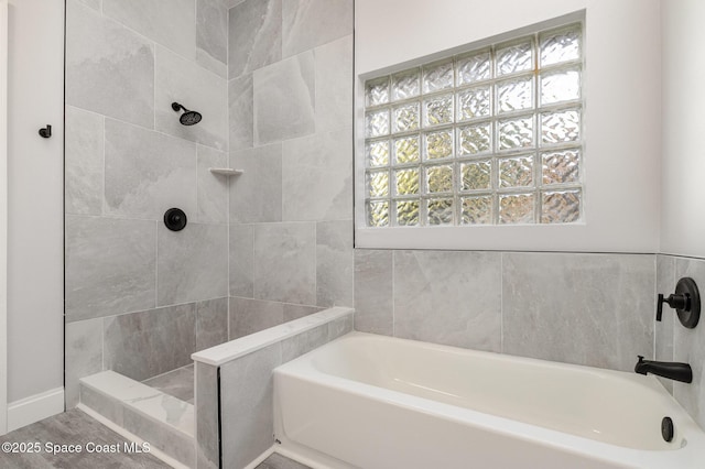 full bath with tiled shower and a garden tub