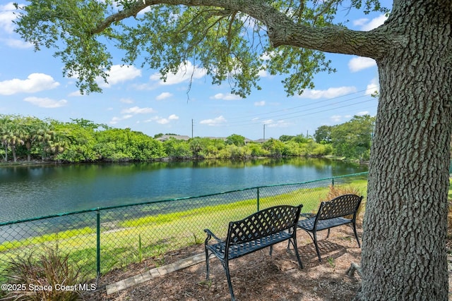 property view of water featuring fence