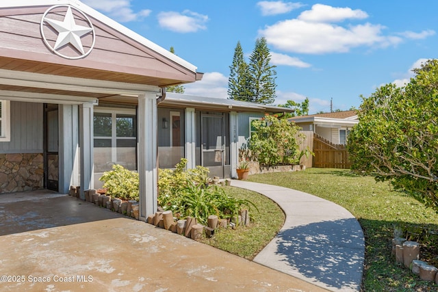 exterior space with a front yard and fence