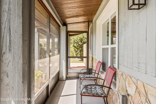 unfurnished sunroom with wood ceiling