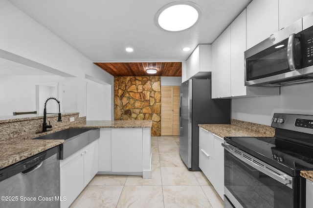 kitchen with wood ceiling, appliances with stainless steel finishes, white cabinets, and a sink