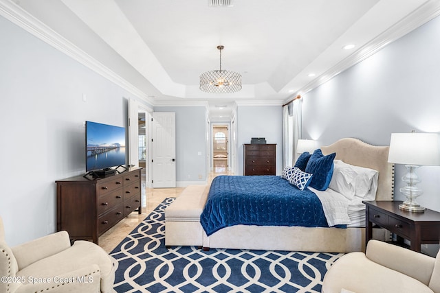 bedroom with recessed lighting, a raised ceiling, and ornamental molding