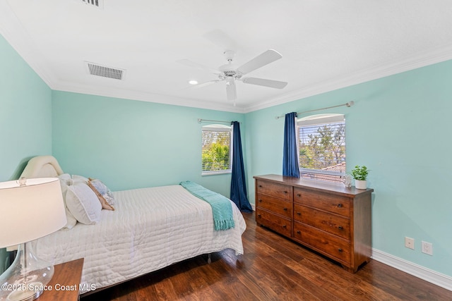 bedroom featuring wood finished floors, visible vents, baseboards, ceiling fan, and crown molding