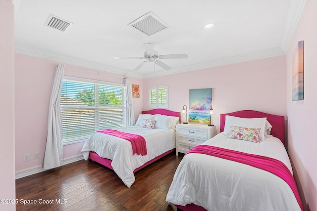 bedroom featuring visible vents, crown molding, and wood finished floors