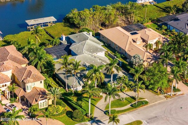 drone / aerial view featuring a residential view and a water view