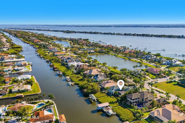 drone / aerial view featuring a residential view and a water view