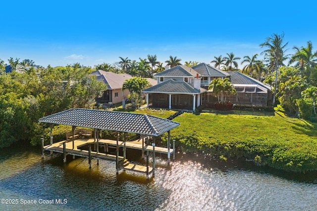 dock area with a yard, a water view, and boat lift