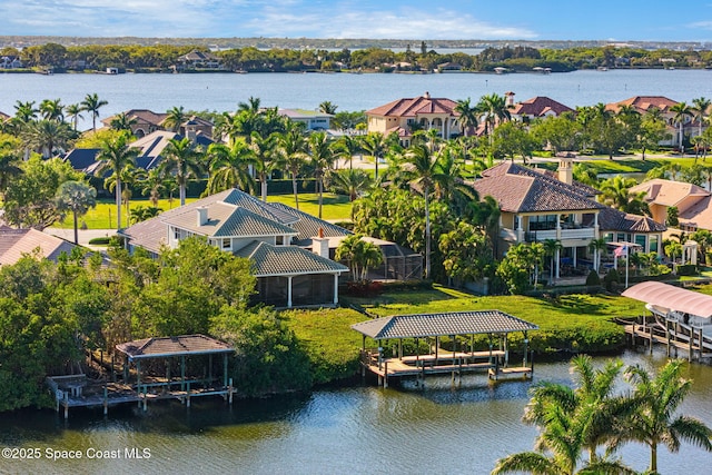 bird's eye view with a residential view and a water view