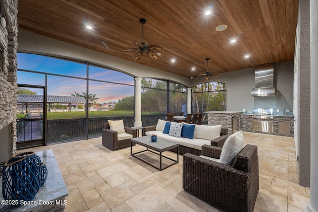 sunroom / solarium with wooden ceiling, a healthy amount of sunlight, and ceiling fan