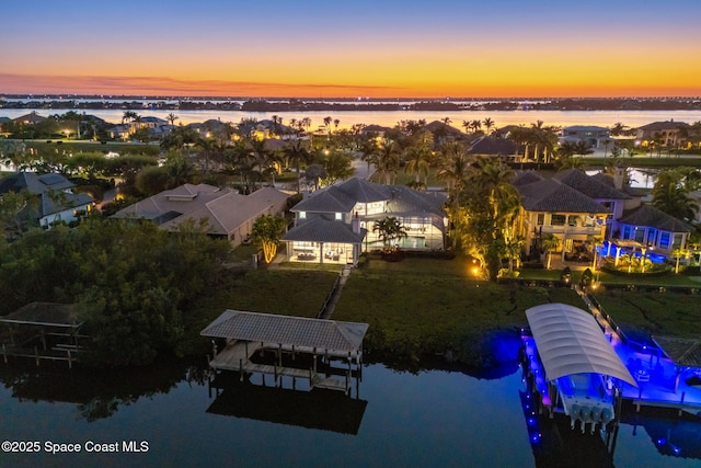 bird's eye view featuring a water view and a residential view