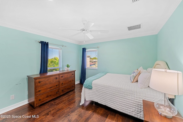 bedroom featuring wood finished floors, visible vents, baseboards, ceiling fan, and crown molding