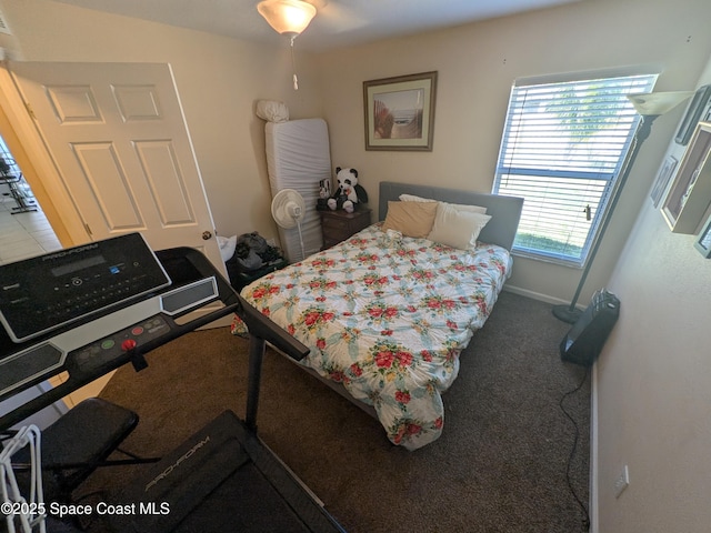 bedroom featuring carpet and baseboards