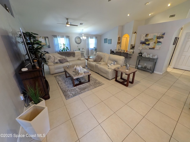 living area featuring lofted ceiling, light tile patterned floors, visible vents, and arched walkways