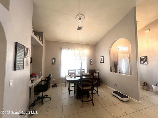 dining area with lofted ceiling, light tile patterned flooring, a chandelier, and visible vents