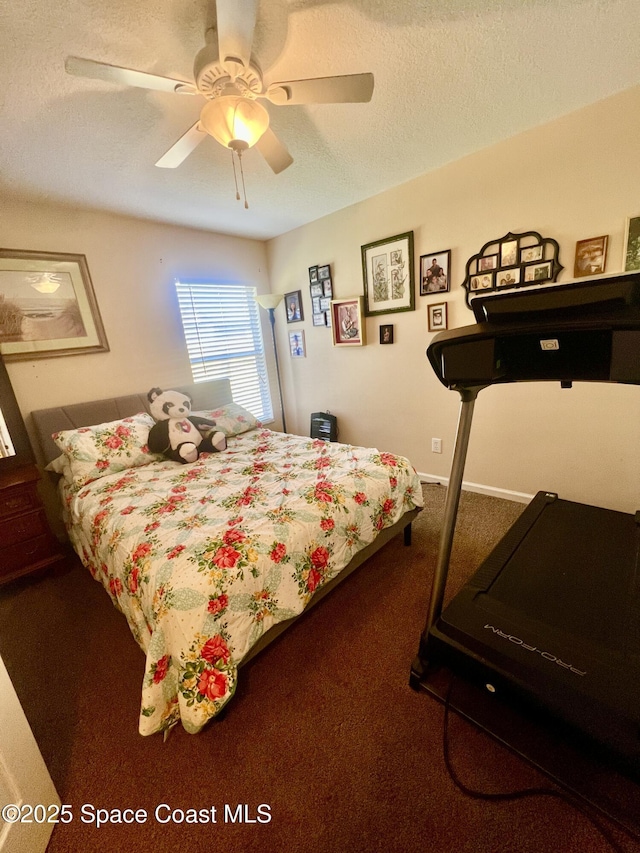 bedroom with carpet floors, ceiling fan, baseboards, and a textured ceiling