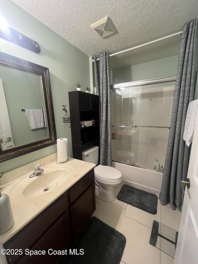 full bath with toilet, tile patterned floors, combined bath / shower with glass door, a textured ceiling, and vanity