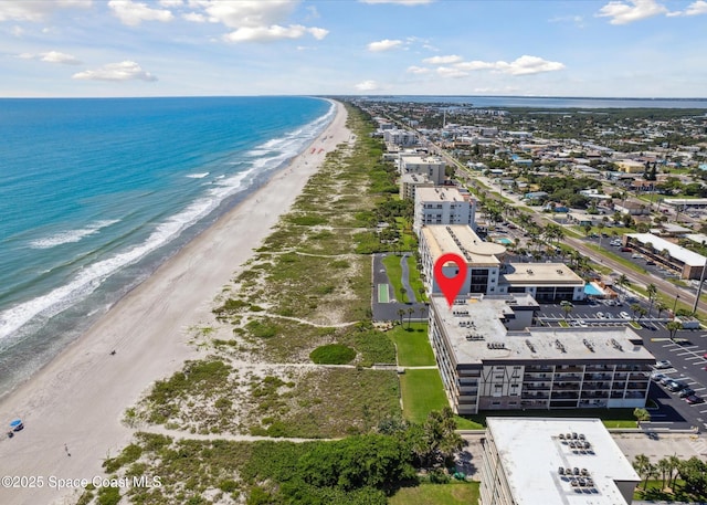 birds eye view of property with a view of the beach and a water view