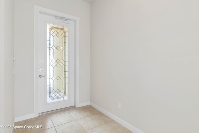 foyer featuring light tile patterned floors and baseboards