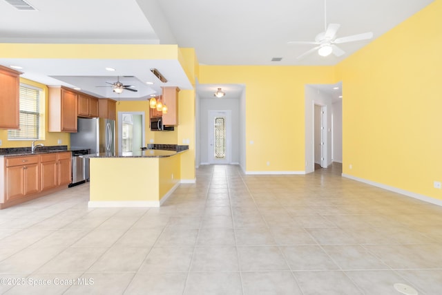 kitchen with ceiling fan, light tile patterned flooring, stainless steel appliances, baseboards, and open floor plan