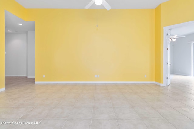 unfurnished room featuring recessed lighting, ceiling fan, baseboards, and light tile patterned floors