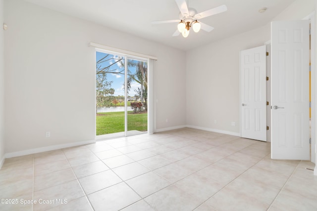 empty room featuring ceiling fan, baseboards, and light tile patterned floors