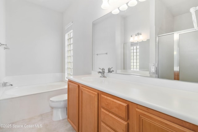 full bath with a garden tub, toilet, a stall shower, vanity, and tile patterned flooring