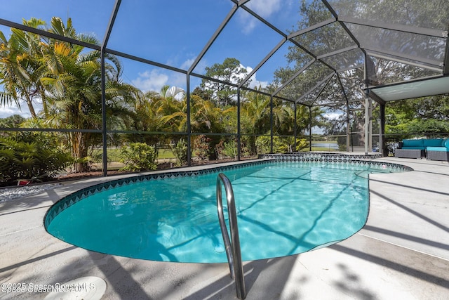 outdoor pool featuring glass enclosure, an outdoor living space, and a patio