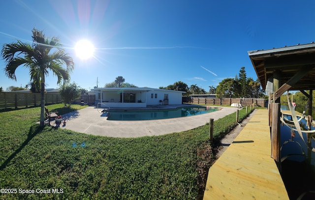 exterior space featuring a yard, a patio area, a fenced in pool, and a fenced backyard