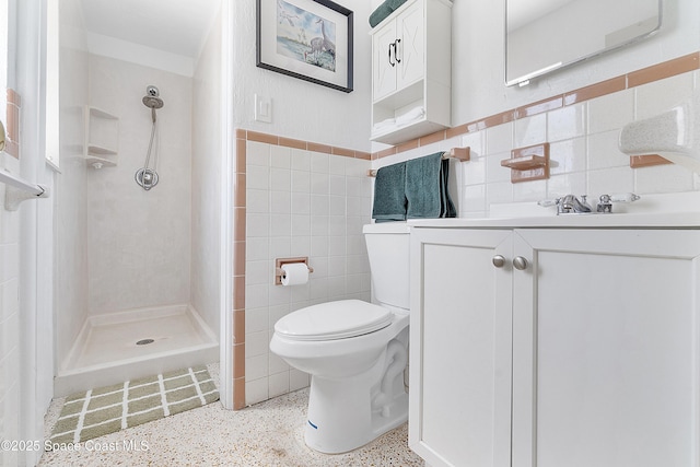 112 Sunset Dr, Cocoa Beach, FL 32931 - full bathroom featuring tile walls, a stall shower, speckle patterned floor, toilet, and vanity