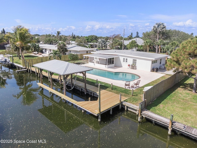 112 Sunset Dr, Cocoa Beach, FL 32931 - dock area featuring a patio area, boat lift, and a water view