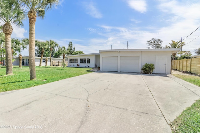112 Sunset Dr, Cocoa Beach, FL 32931 - ranch-style house with stucco siding, concrete driveway, and a garage