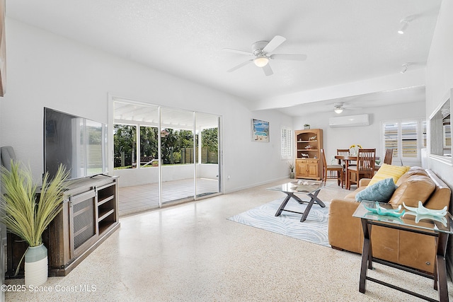 112 Sunset Dr, Cocoa Beach, FL 32931 - living area featuring a wall mounted AC, ceiling fan, and speckled floor