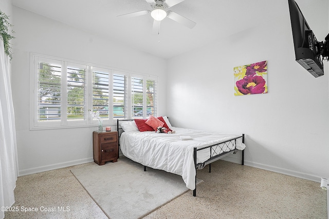 112 Sunset Dr, Cocoa Beach, FL 32931 - bedroom with speckled floor, baseboards, and a ceiling fan