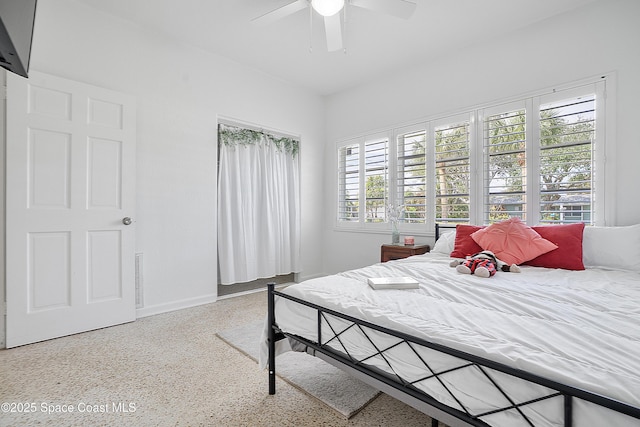 112 Sunset Dr, Cocoa Beach, FL 32931 - bedroom with speckled floor, ceiling fan, and baseboards