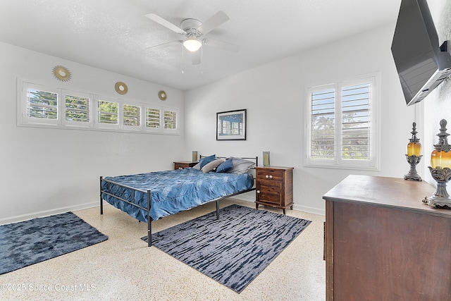 112 Sunset Dr, Cocoa Beach, FL 32931 - bedroom with baseboards, dark aggregate flooring, and ceiling fan