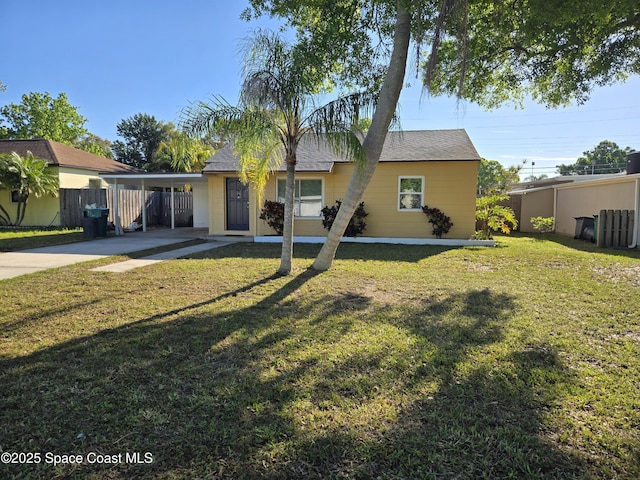 view of front of house featuring a carport, a front yard, concrete driveway, and fence