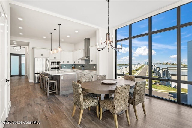 225 Strand Dr Unit 401, Melbourne Beach, FL 32951 - dining space with baseboards, floor to ceiling windows, recessed lighting, a notable chandelier, and dark wood-style flooring