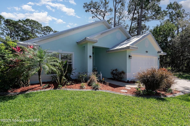 view of front facade with a garage, concrete driveway, a front yard, and stucco siding