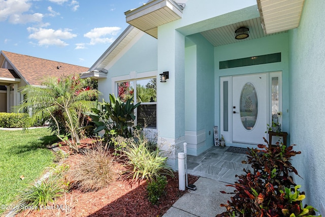 property entrance with stucco siding