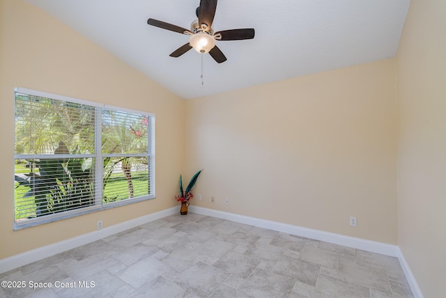 spare room featuring lofted ceiling, ceiling fan, and baseboards