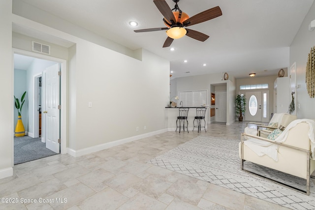 living area with baseboards, a ceiling fan, visible vents, and recessed lighting