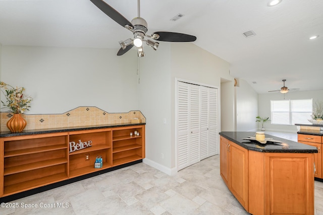 kitchen with recessed lighting, visible vents, backsplash, a kitchen island, and baseboards