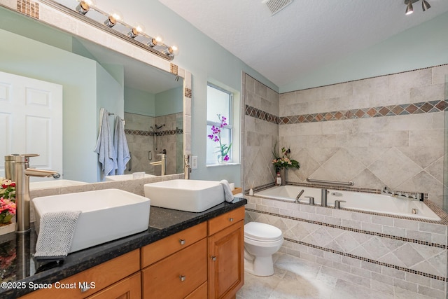 bathroom featuring lofted ceiling, visible vents, a sink, and double vanity