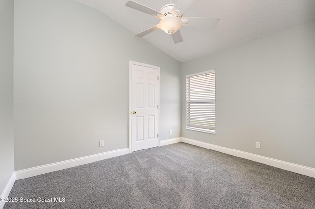 empty room with carpet floors, lofted ceiling, baseboards, and a ceiling fan