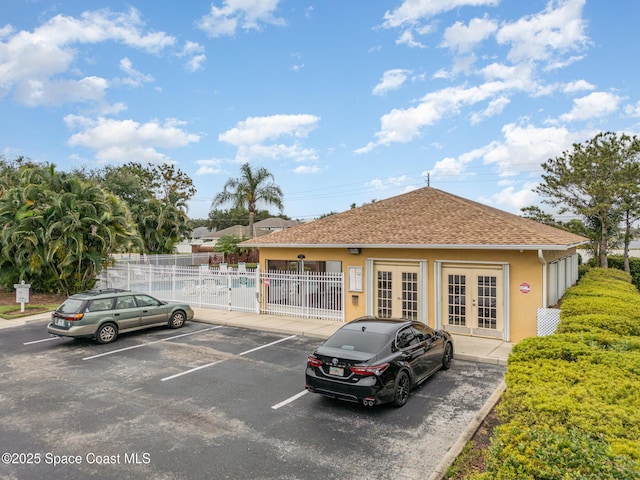 exterior space featuring uncovered parking and fence