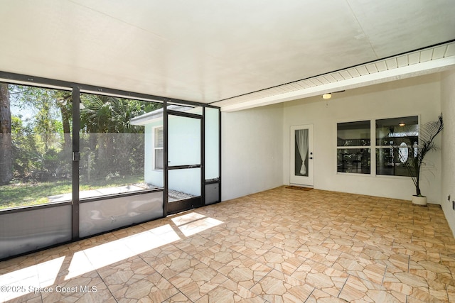 unfurnished sunroom featuring a healthy amount of sunlight