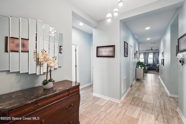 corridor with recessed lighting, visible vents, and baseboards